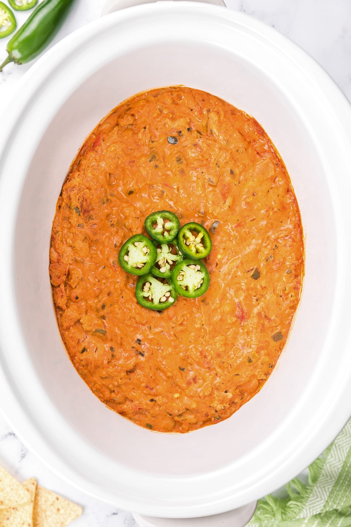 Overhead shot of jalapeno popper chili in crockpot.