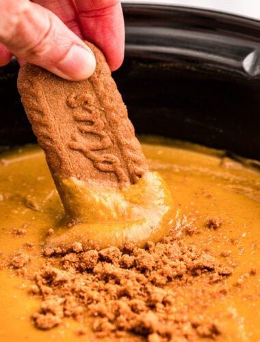 cookie being dipped into pumpkin pie dip.