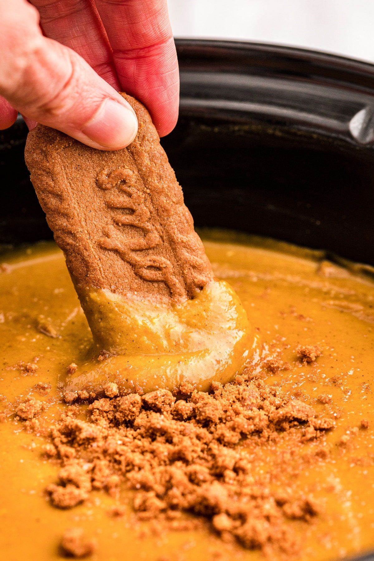 cookie being dipped into pumpkin pie dip.