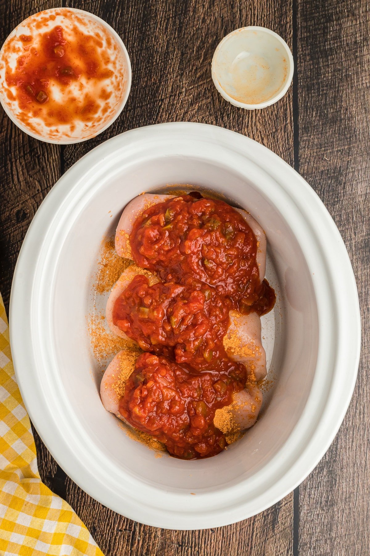 chicken breasts with salsa and taco seasoning on top.