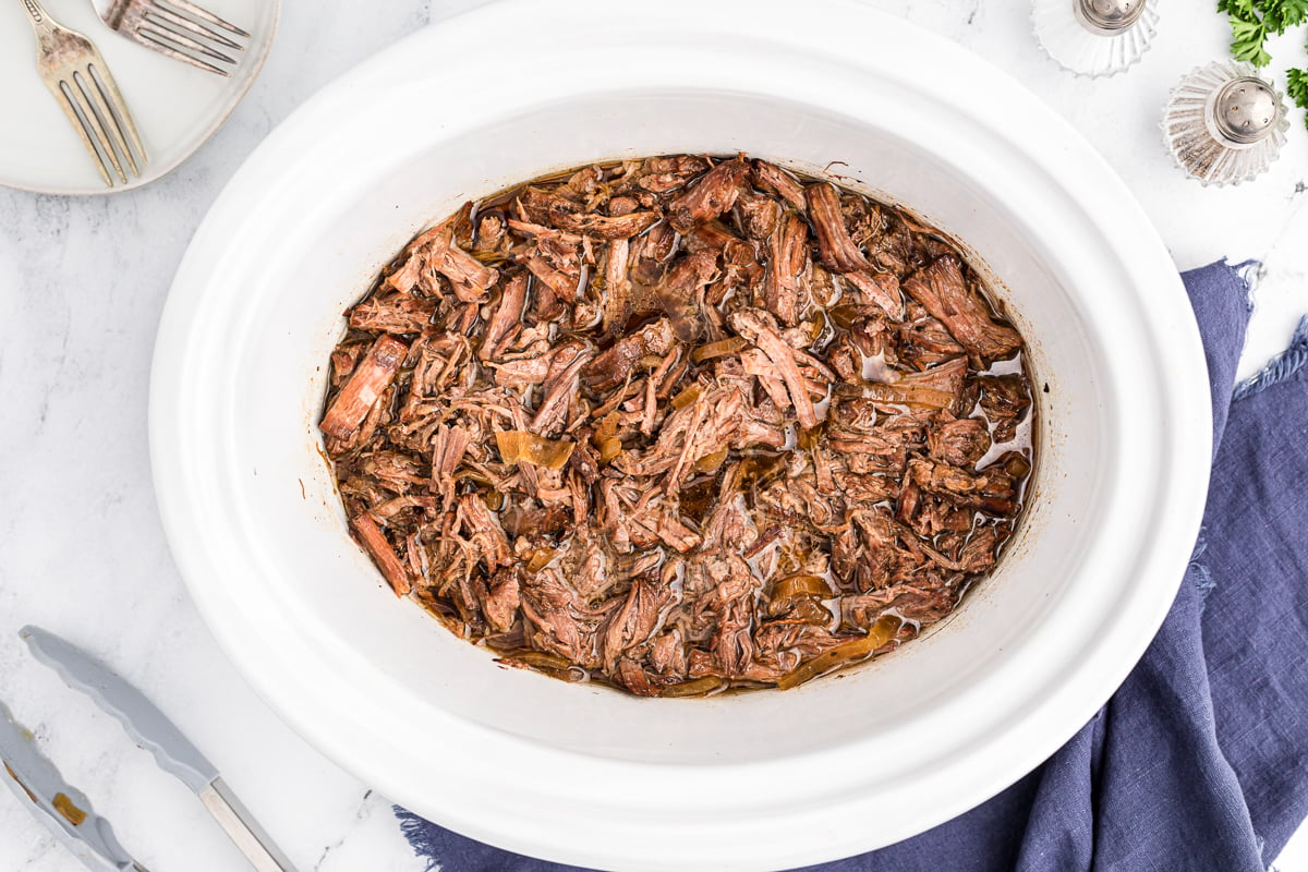 Amish pot roast in a white crockpot.