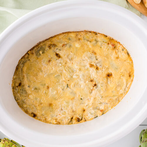 cooked artichoke dip in a slow cooker.