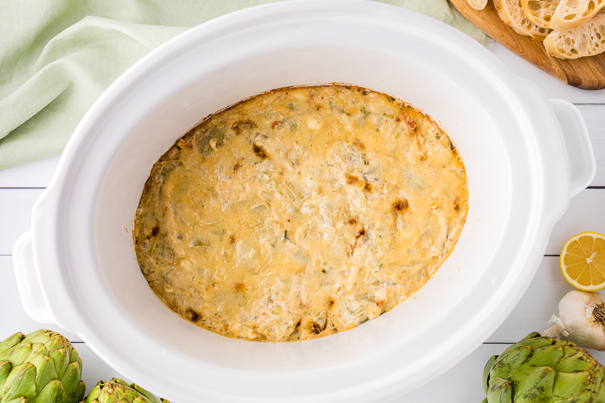 cooked artichoke dip in a slow cooker.