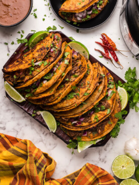 many birria tacos on a platter.