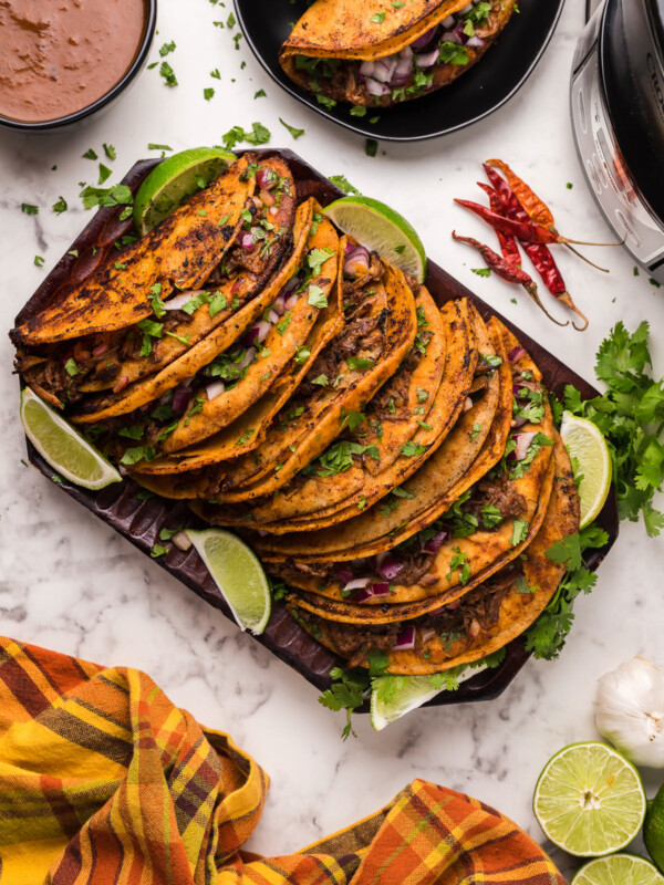 many birria tacos on a platter.