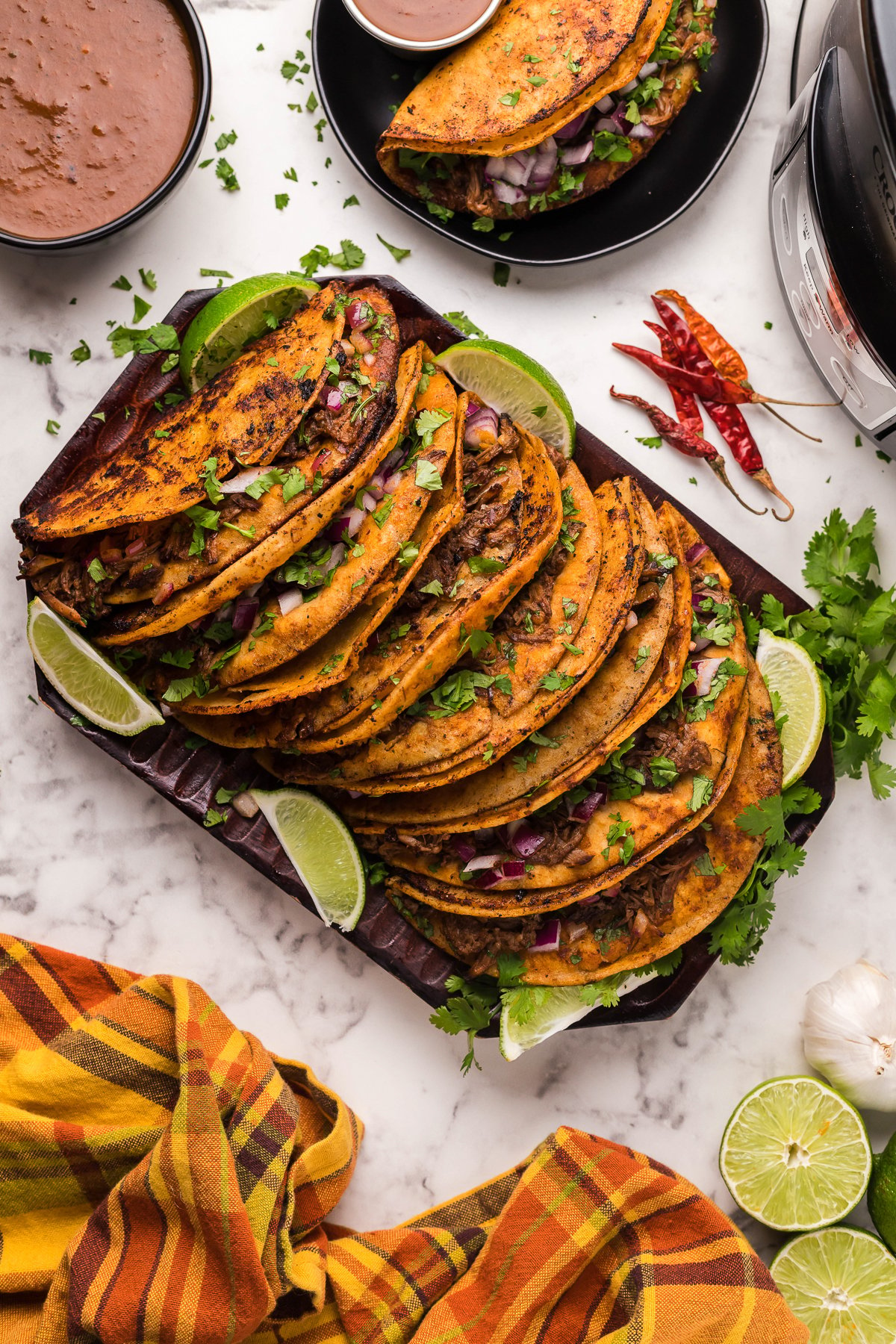 many birria tacos on a platter.