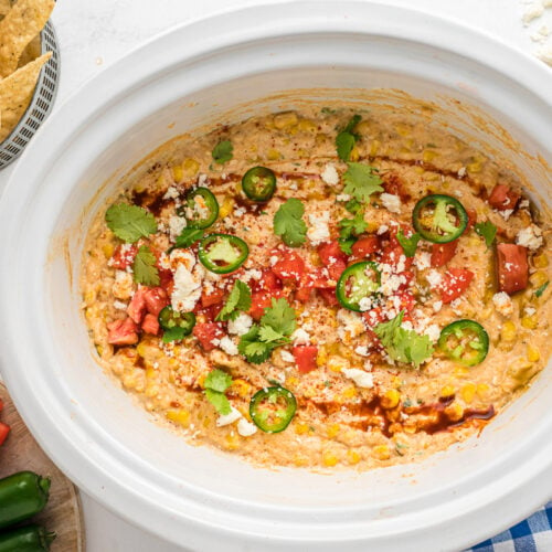 corn dip with toppings on top.