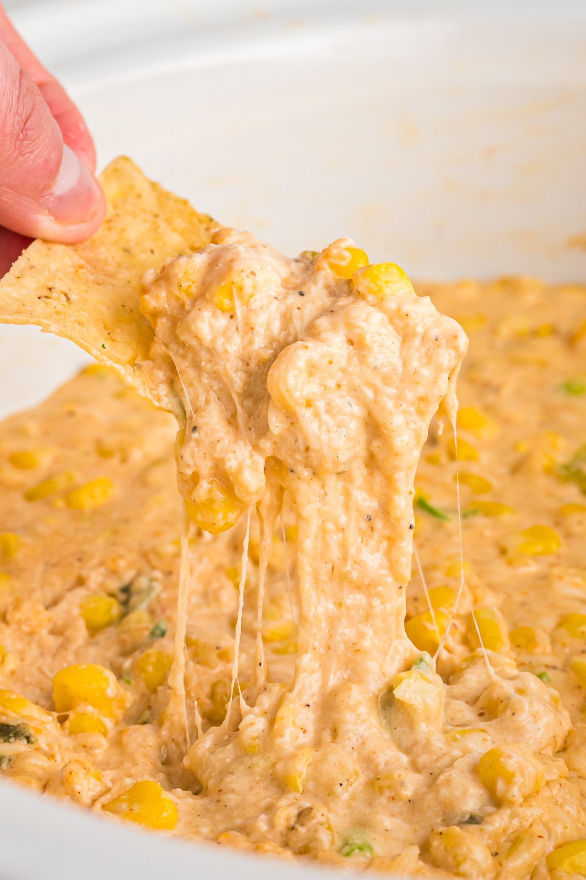 Cheesy corn dip on a chip.