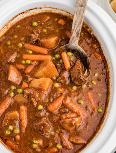 Beef stew done cooking in a crockpot.