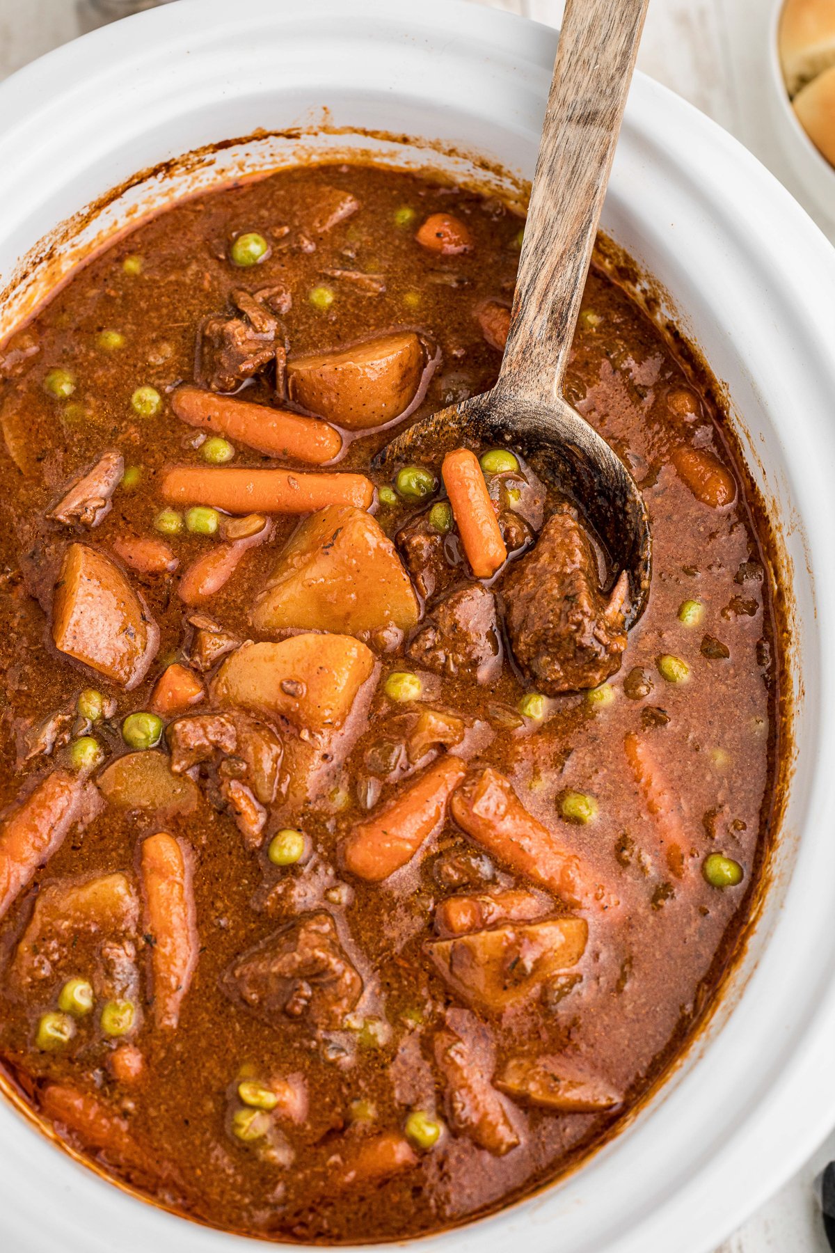 Beef stew done cooking in a crockpot.