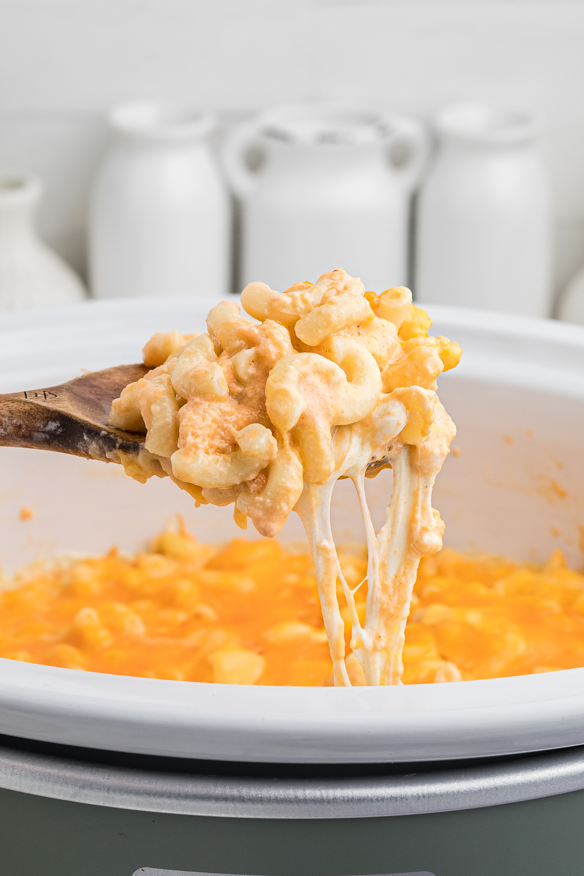 crockpot mac and cheese on a spoon.