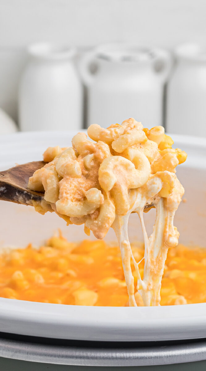 Long image of mac and cheese on a spoon for pinterest.