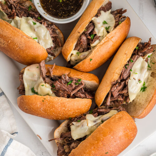 4 french dip sandwiches with au jus.