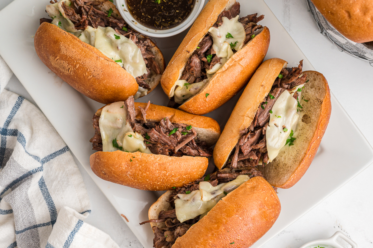 4 french dip sandwiches with au jus.