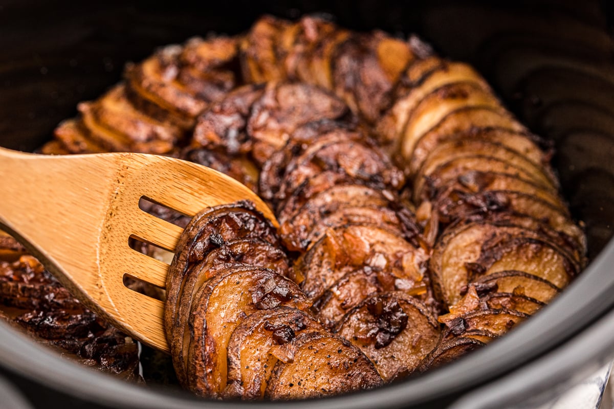 Cooked lipton onion potatoes on a wooden spoon