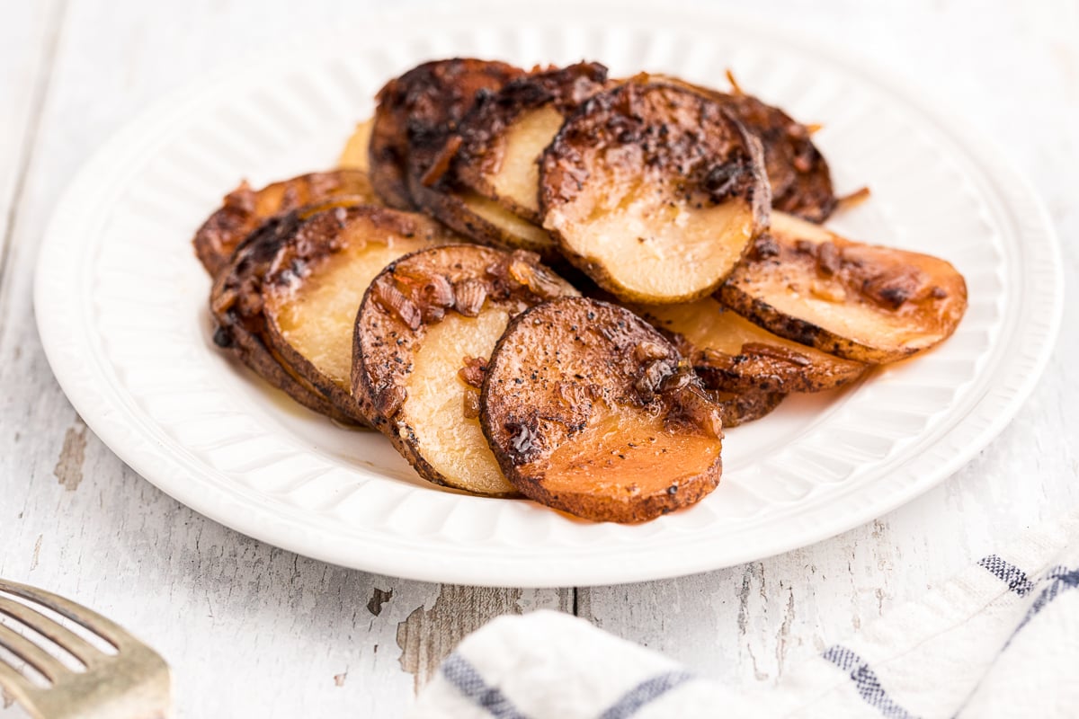 Plate of sliced potatoes with lipton onion soup mix flavor.