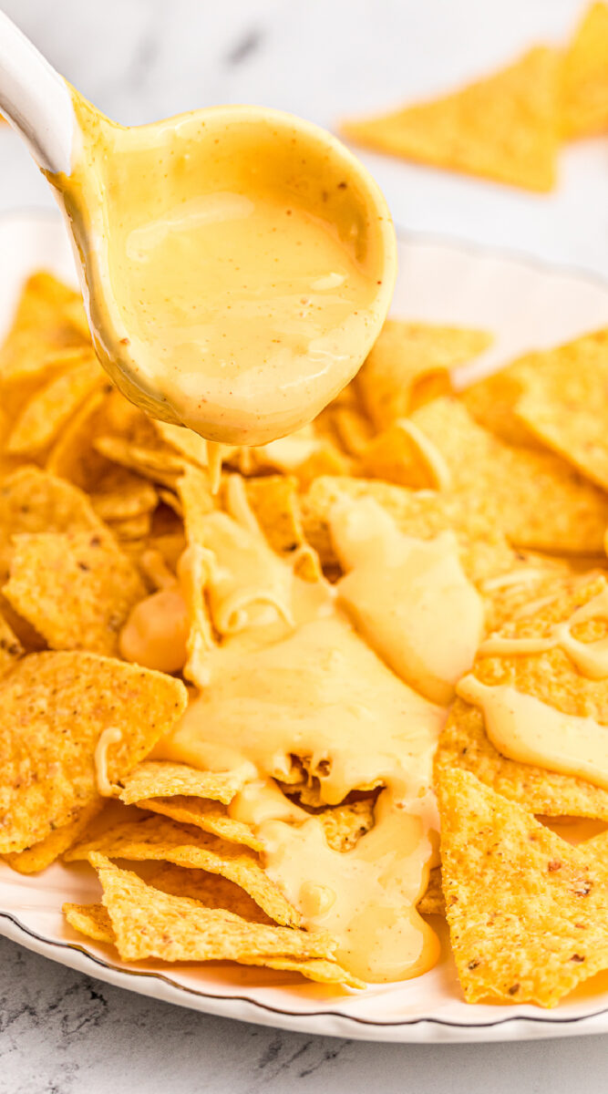 long image of nacho cheese on chips.