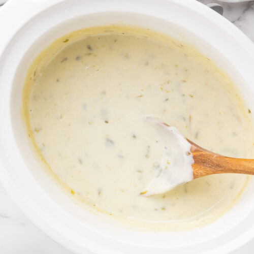 cooked white queso in a crockpot.