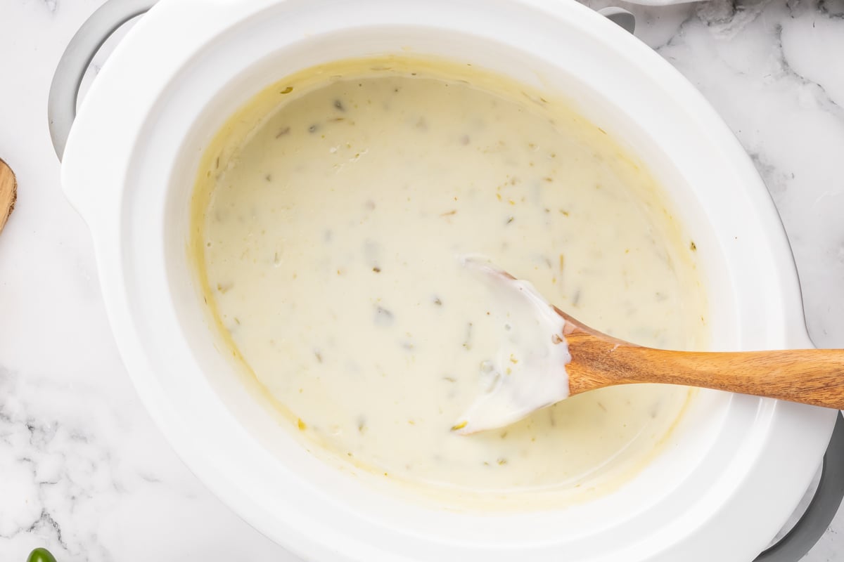 cooked white queso in a crockpot.