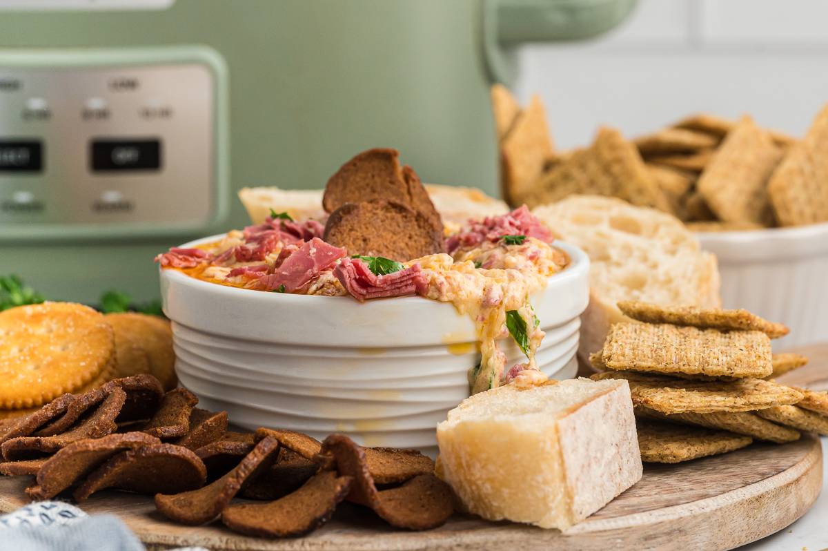 Reuben dip slightly spilling over side of a bowl.