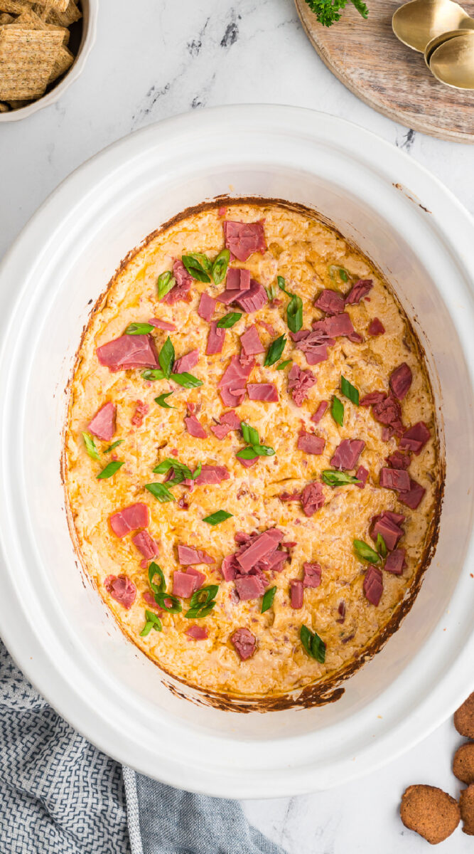 Reuben dip with pieces of corned beef on top.