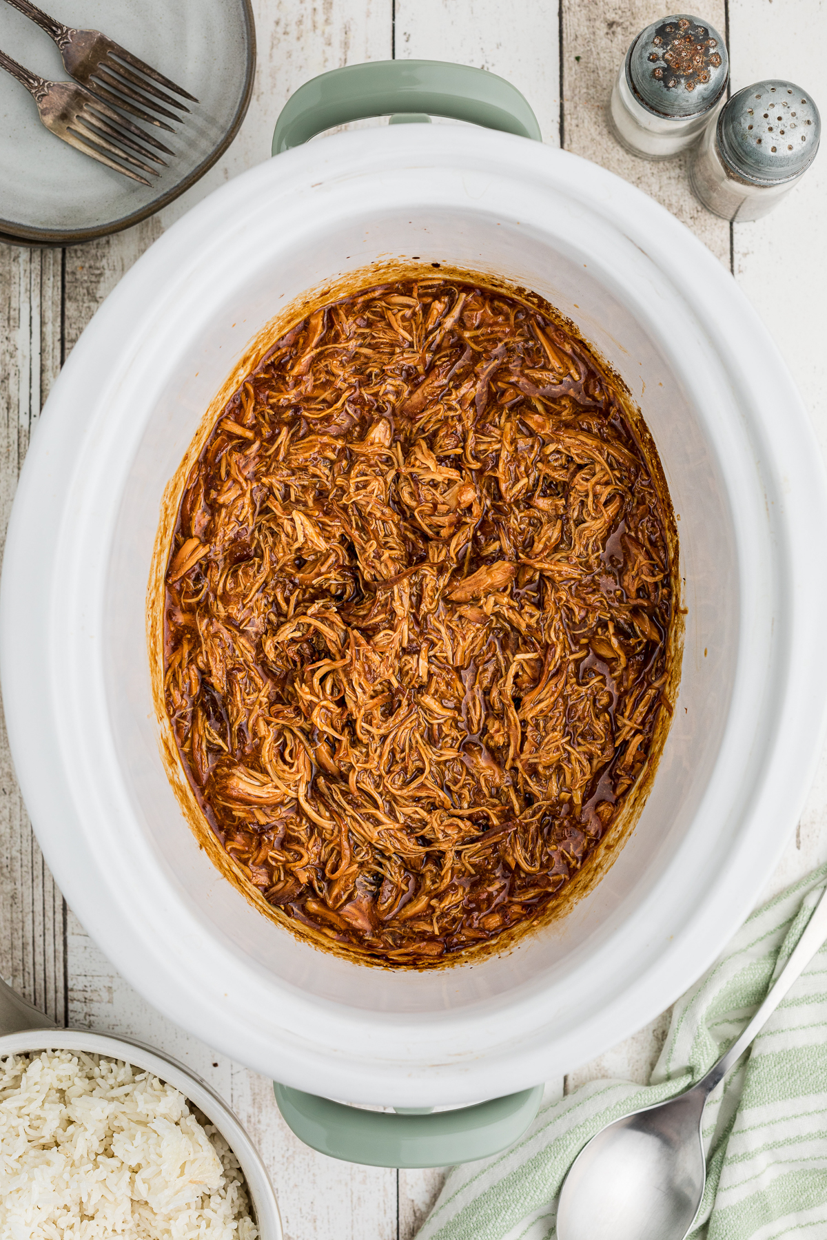 Shredded apricot chicken in a slow cooker.
