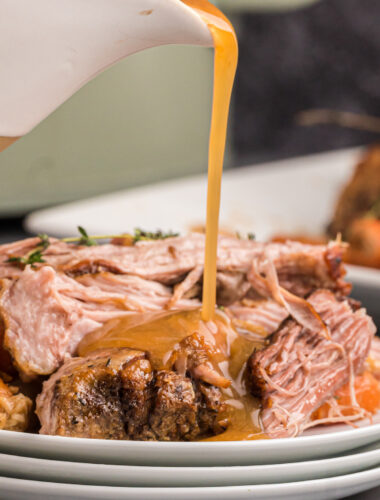 pork pot roast with gravy being poured over.