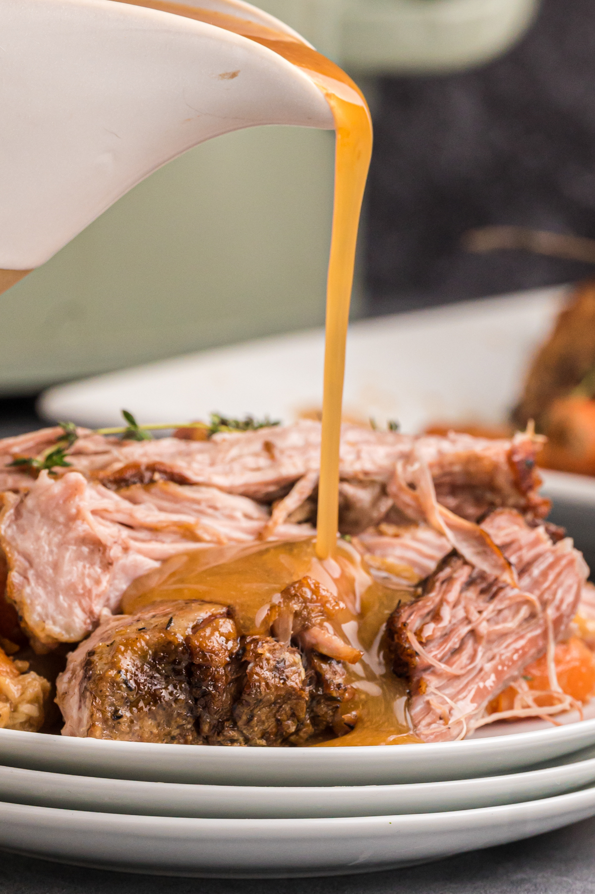 pork pot roast with gravy being poured over.