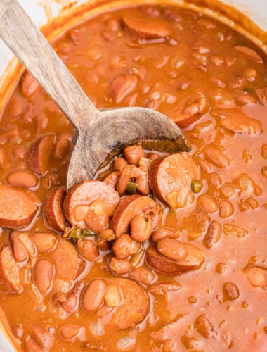 Cooked beans with kielbasa in a slow cooker.