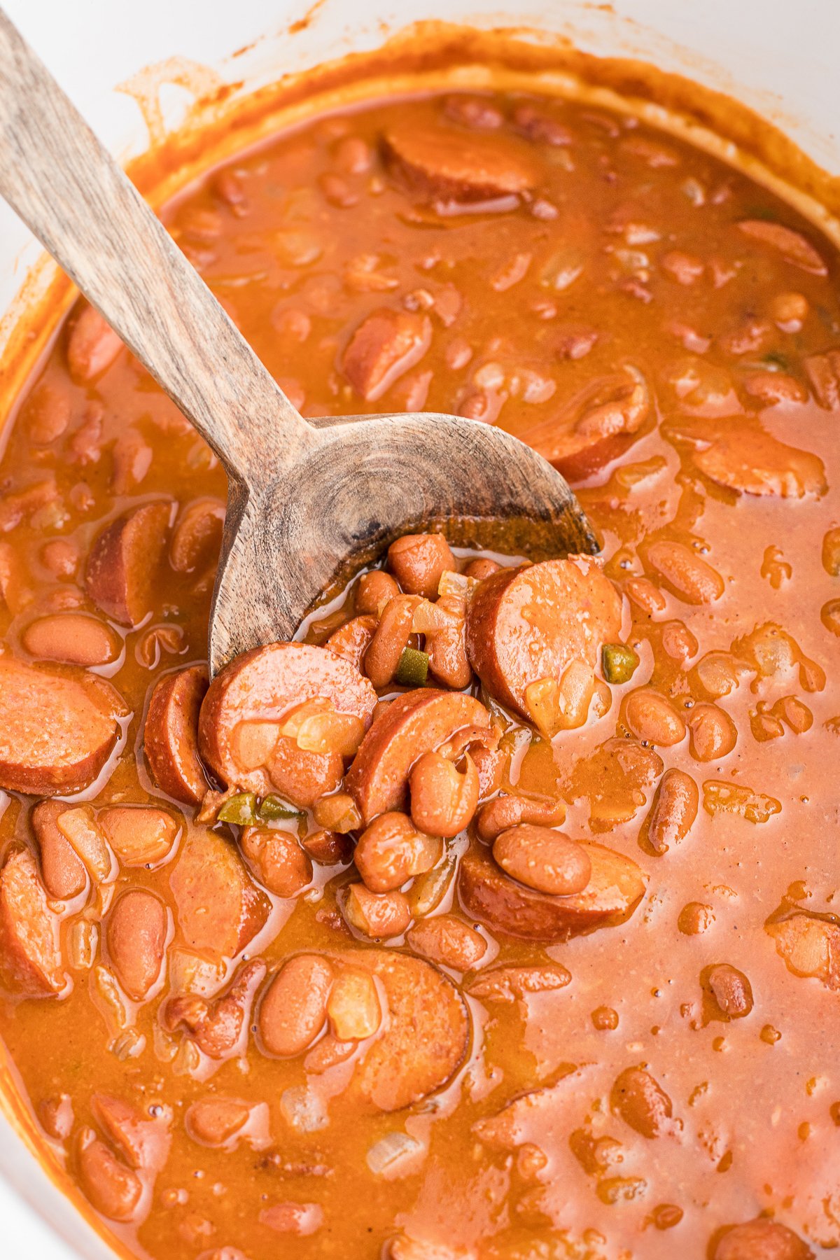 Cooked beans with kielbasa in a slow cooker.