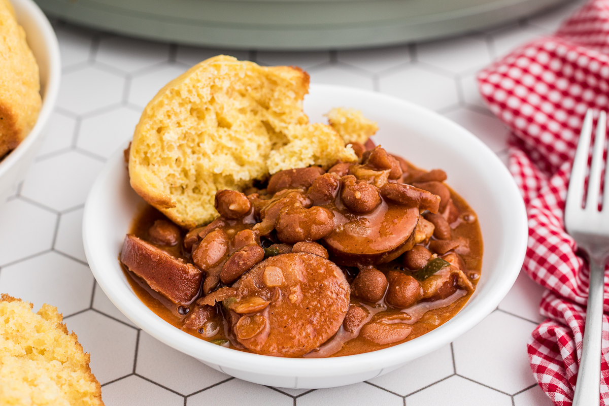 bowl of beanies and weenies with cornbread.