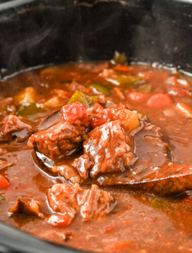 goulash on a wooden spoon.