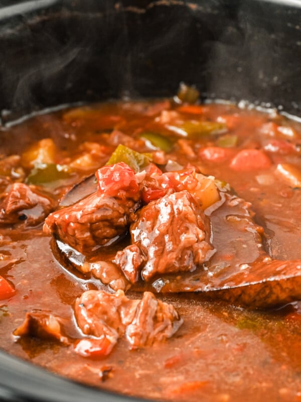 goulash on a wooden spoon.