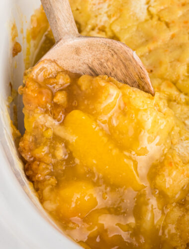 peach cobbler on a wooden spoon.