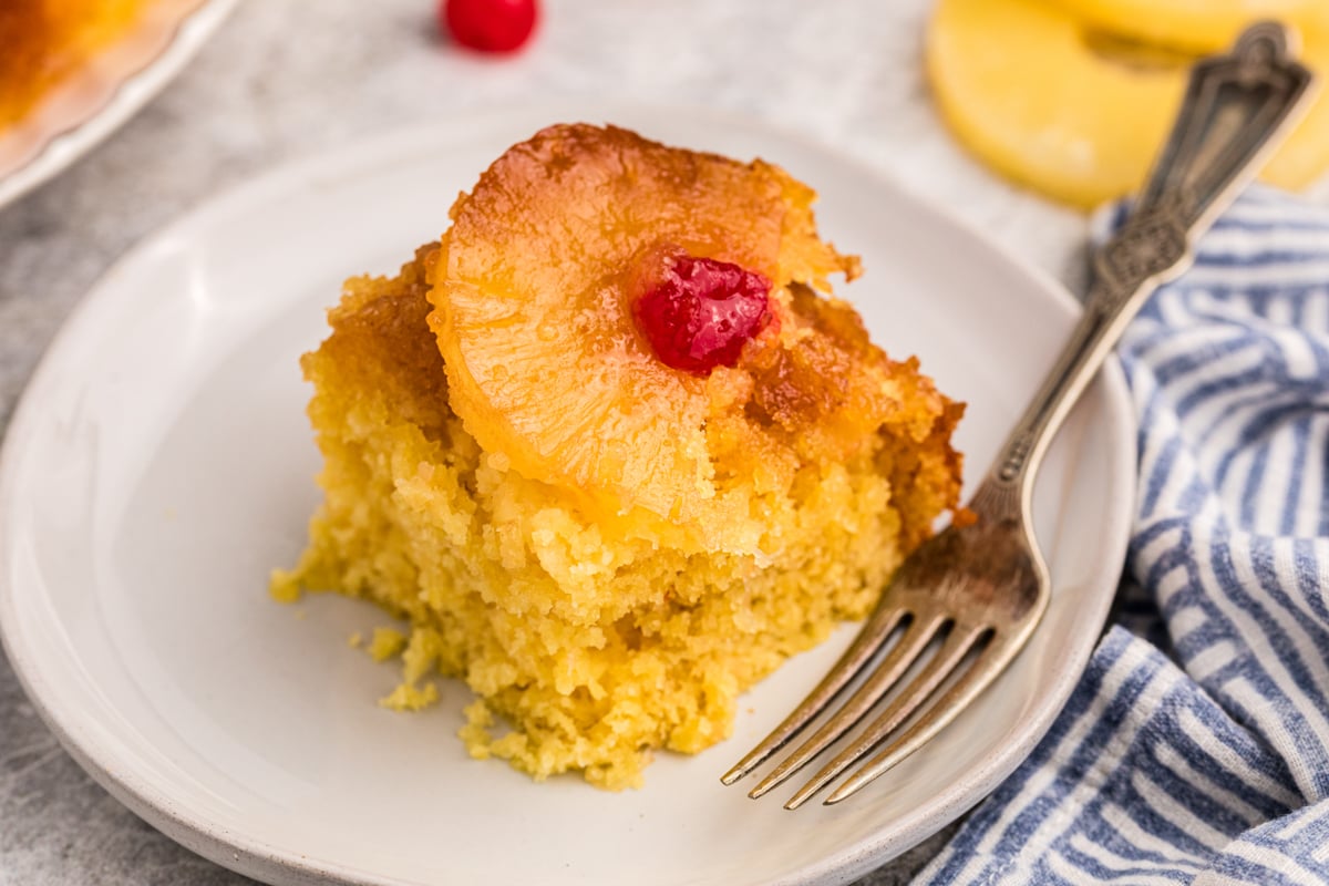 slice of pineapple upside down cake on a plate.