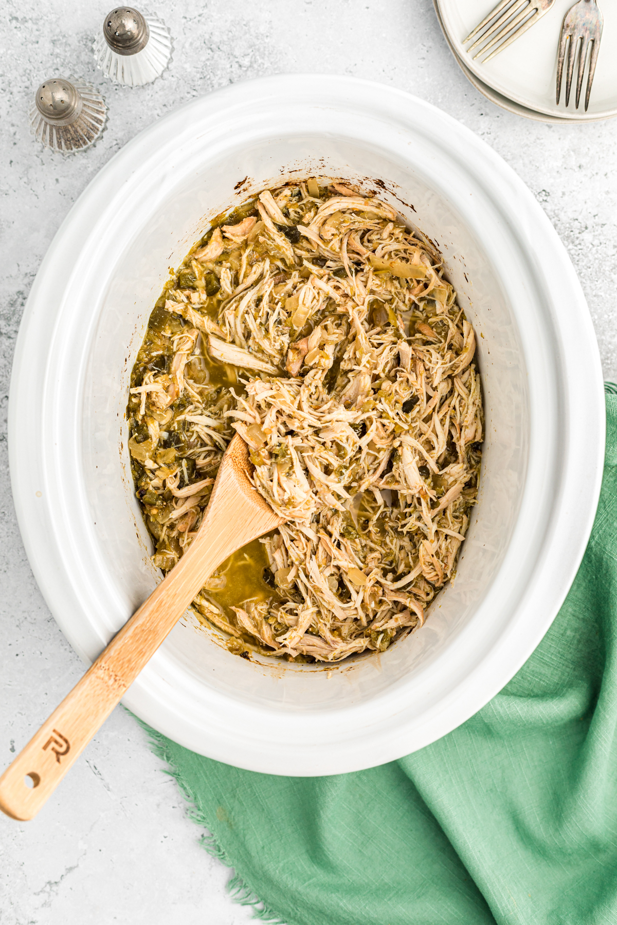 salsa verde chicken, shredded in the slow cooker.