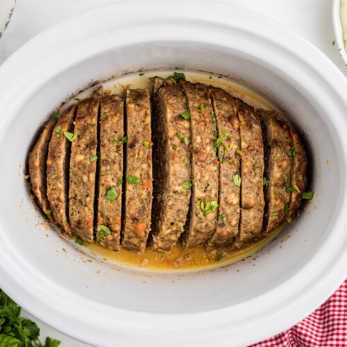 overhead shot of turkey meatloaf in a white slow cooker.