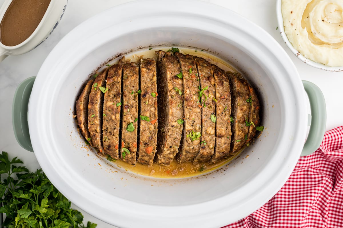 overhead shot of turkey meatloaf in a white slow cooker.