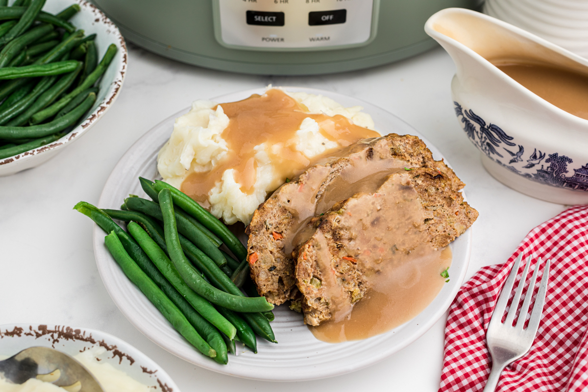 plate with mashed potaotes, green beans and turkey meatloaf.