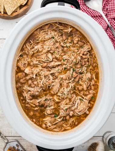 Cooked pinto beans and chicken in a crockpot.