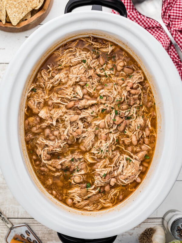Cooked pinto beans and chicken in a crockpot.