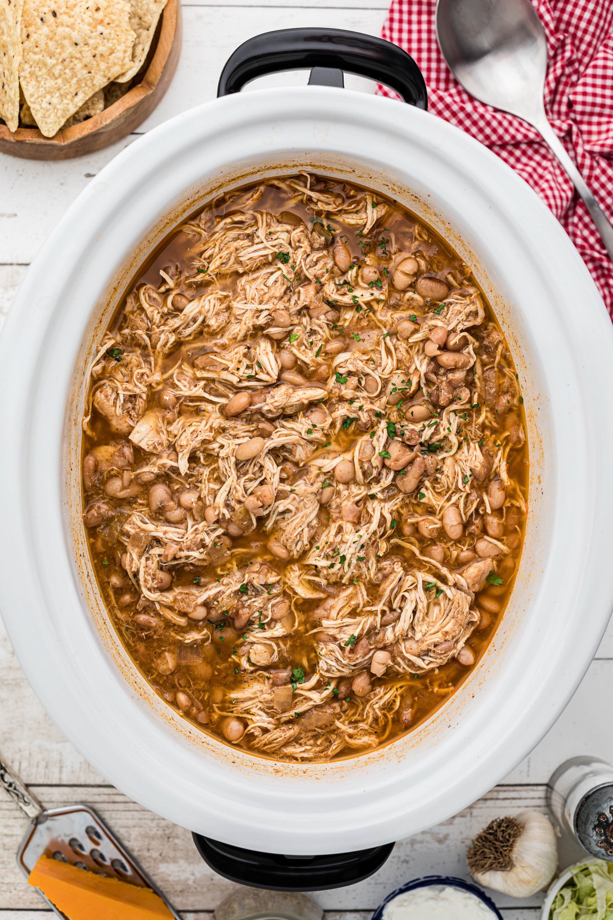 Cooked pinto beans and chicken in a crockpot.