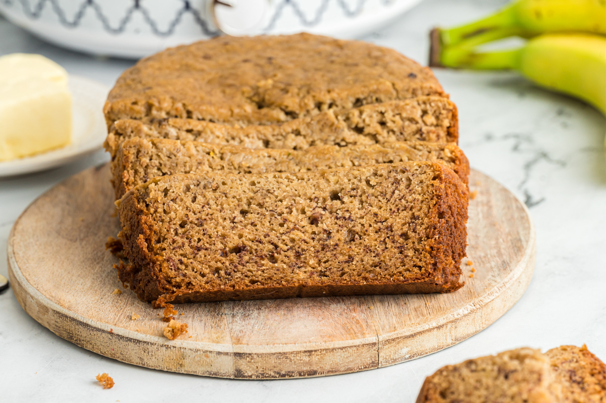 sliced banana bread in front of a slow cooker.