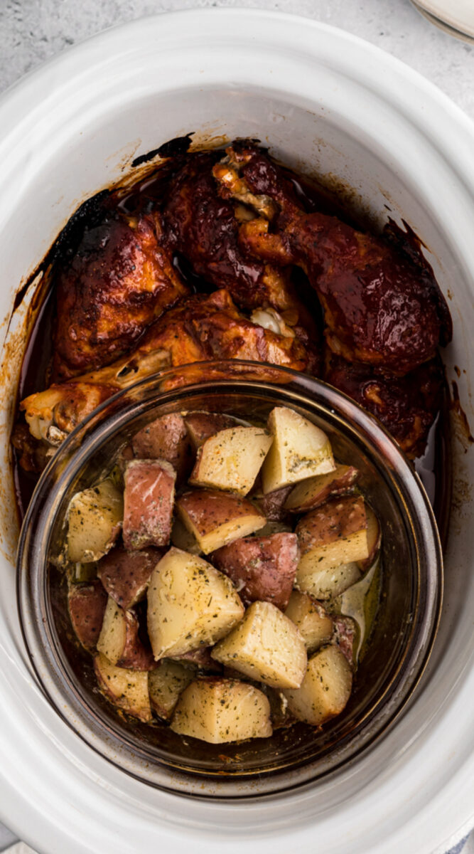 close up of chicken and drumsticks in a slow cooker.