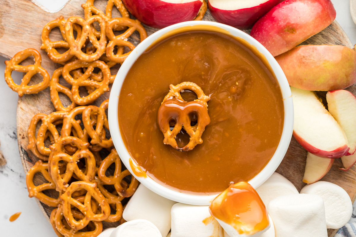 caramel dip with pretzel on top.