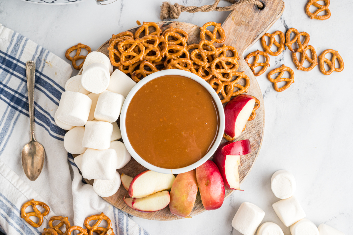 platter with caramel, marshmallows, apples and pretzels.