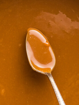 close up of caramel dip on a spoon.