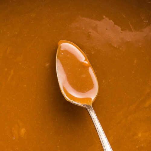close up of caramel dip on a spoon.