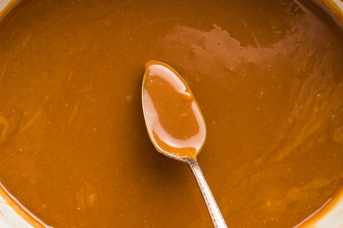 close up of caramel dip on a spoon.