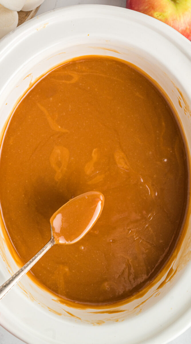 long image of caramel dip on a spoon.